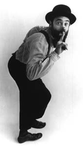Avner raises his finger to his lips in a shh gesture